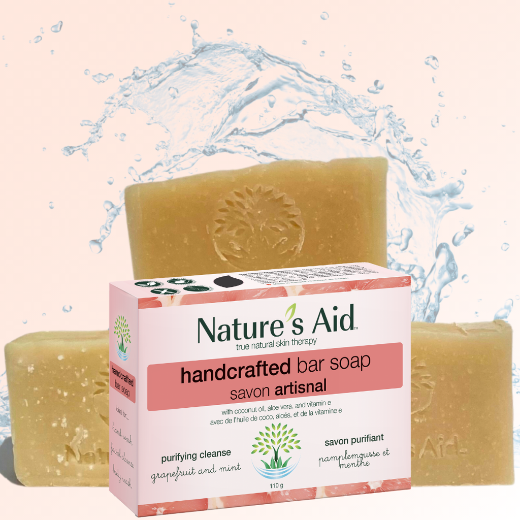 Nature's Aid handcrafted bar soap with packaging on a water splash background