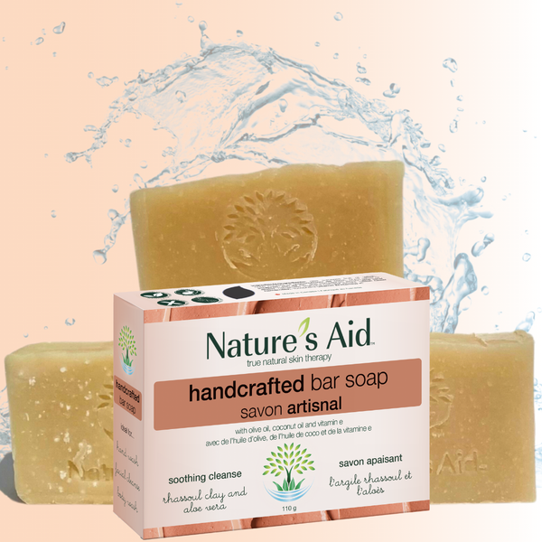 Nature's Aid handcrafted bar soap with packaging on a water splash background