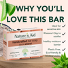 Nature's Aid handcrafted bar soap packaging with aloe vera leaves on a wooden surface