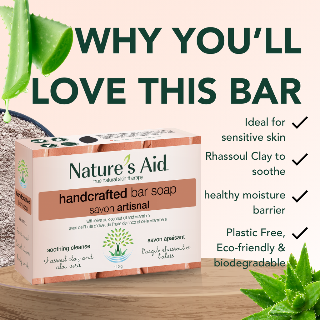 Nature's Aid handcrafted bar soap packaging with aloe vera leaves on a wooden surface