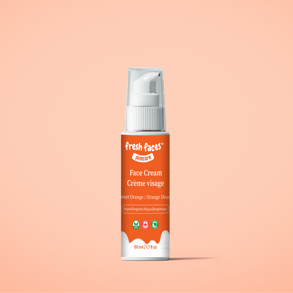 Face cream bottle with pump on a peach background