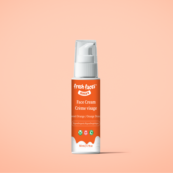 Face cream bottle with pump on a peach background