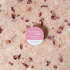 Bath salt with rose petals and a pink label on top