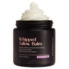 Whipped tallow balm jar with cream on top on a white background
